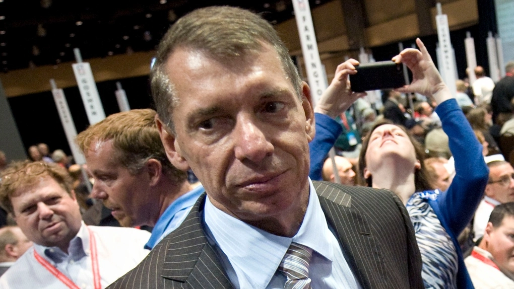 Certainly, here are three alternative text (alt text) options for an image related to the topic: 1. Alt Text 1: "Vince McMahon addressing the WWE audience amidst controversy" 2. Alt Text 2: "Image of Vince McMahon, WWE founder, during a press conference" 3. Alt Text 3: "A news headline featuring Vince McMahon's resignation amid allegations"