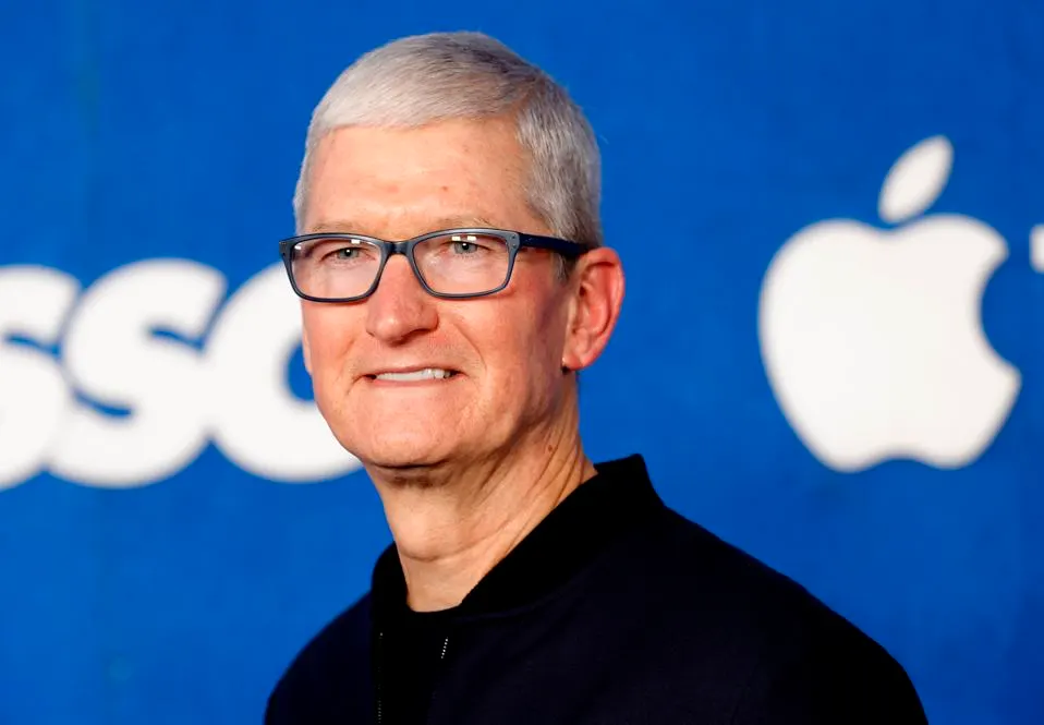 Tim Cook standing thoughtfully in front of an Apple logo, reflecting on strategic decisions for the company's future.