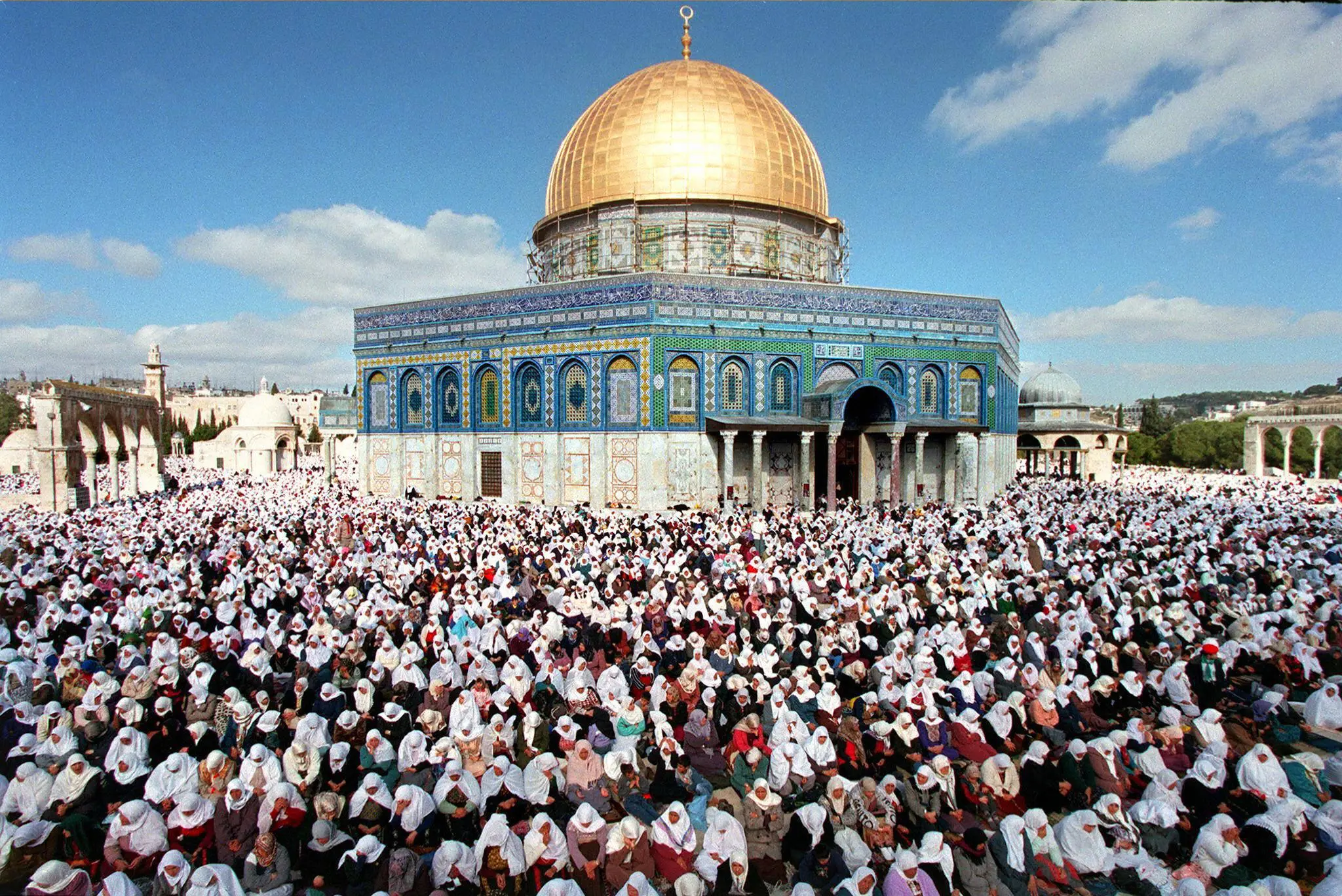 A mosque illuminated at night for Taraweeh prayers during Ramadan in Palestine.