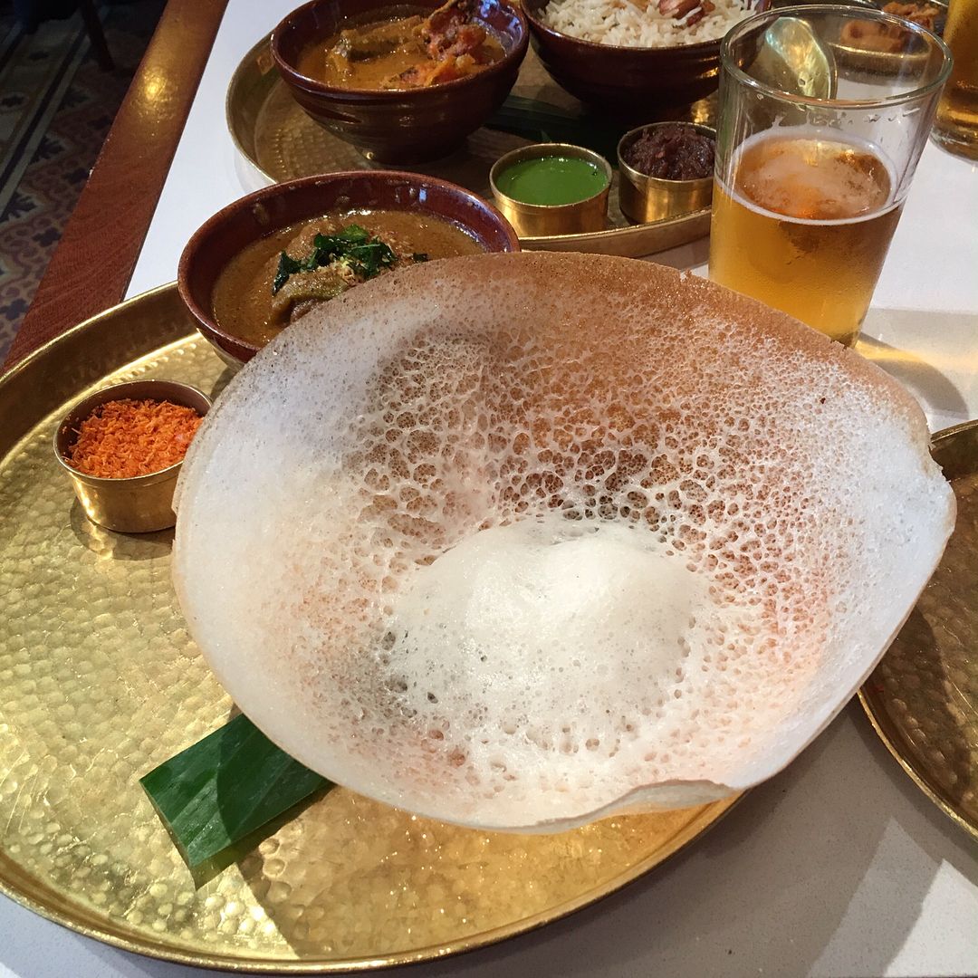 Traditional South Indian appam served with a side of coconut chutney.