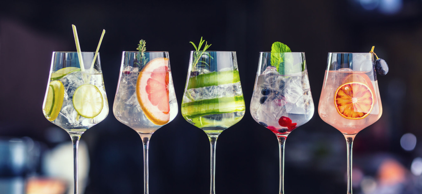 Ingredients for making a Negroni, arranged on a bar counter, symbolizing the creativity and tradition of World Cocktail Day.