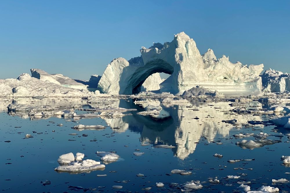 A panoramic view of the Ilulissat Icefjord with sparkling blue ice formations 