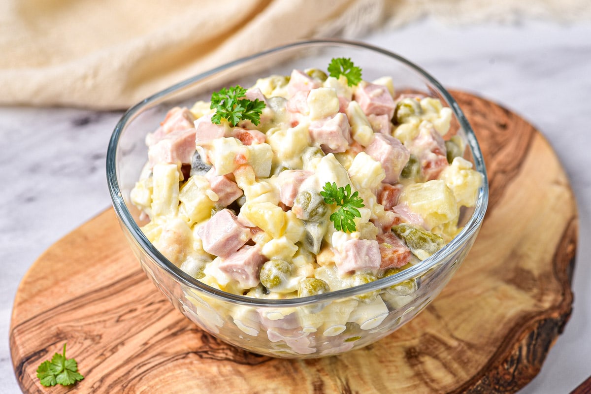 Olivie Salad served as a side dish with crusty bread 